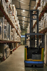 Fototapeta na wymiar Vertical background image of warehouse interior with forklift by tall shelves