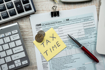 cloeup of 1040 US federal income tax return form with pen