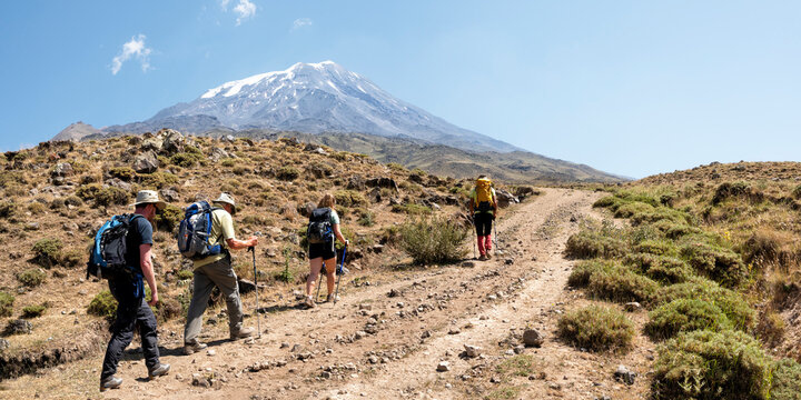 Friends hiking towards Mount Ararat on sunny day