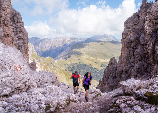Man and woman hiking at Forcella Della Roa, Dolomites, Italy
