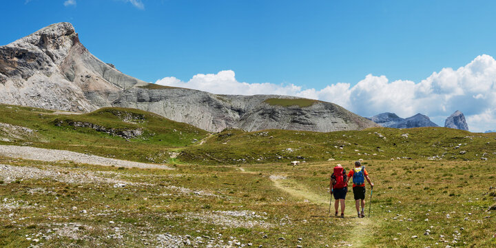 Couple hiking towards Rifugio Puez, Dolomites, Italy