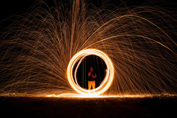 Spinning and burning Steel wool sparkle fire in the circle shape with long speed shutter shoot...