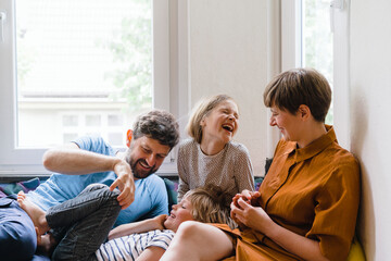 Happy family enjoying together sitting at home
