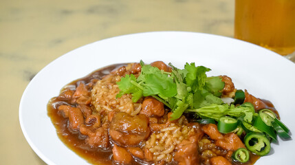 Chicken gravy over rice is a hearty and flavorful dish that combines tender chunks of chicken with a rich and savory gravy, served over a bed of fluffy white rice