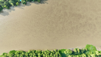 From high above, a bird's eye view reveals the shimmering surface of the Bang Pakong River, winding...
