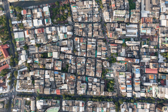 A high shot topview reveals the endless maze of houses and housing that make up the bustling city of Bangkok, each one teeming with activity. shot date 6 Nov 2018.