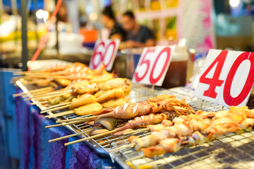 cooked squid They come in a variety of sizes and are easy to eat. The number 60, 50, 40 is the price of grilled squid stick in Thai Baht.