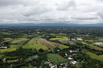 Obraz premium seen from a high perspective. Note the contrast between the sky's circling clouds and the green grass trees at Pa Sang District, Lamphun Province, Thailand.