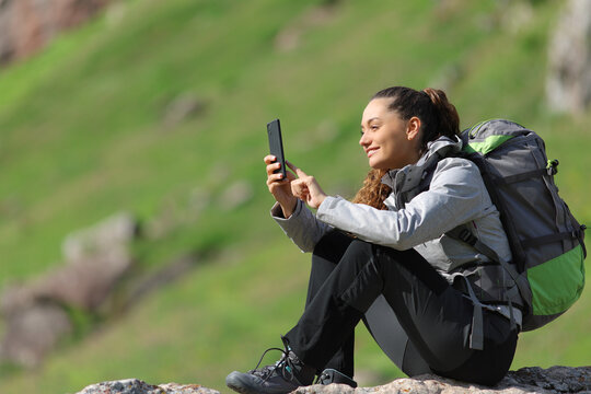 Hiker using smart phone in nature