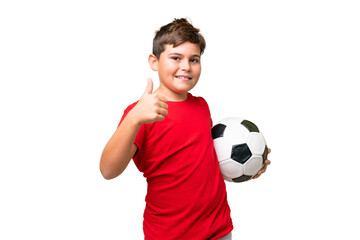 Little caucasian kid over isolated chroma key background with soccer ball and with thumb up
