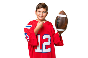 Little caucasian kid playing rugby over isolated chroma key background and pointing it