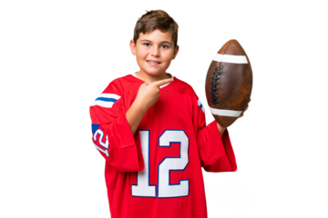 Little caucasian kid playing rugby over isolated chroma key background and pointing it