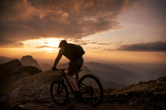 Mountain biker riding on slope at mountain
