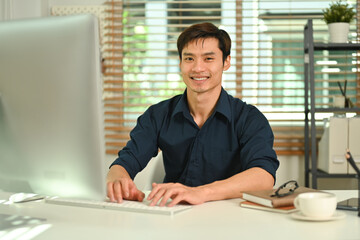 Fototapeta na wymiar Portrait of successful asian businessman entrepreneur using laptop, managing his small business from home