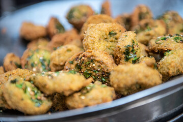 A close up detail of freshly cooked deep fried Falafel, a chickpea and herb filled snack popular in...