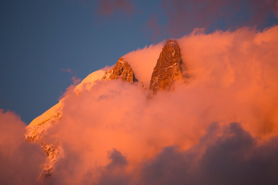 Pink evening light (Alpenglow) on the famous Drus mountain, as seen from Chamonix.