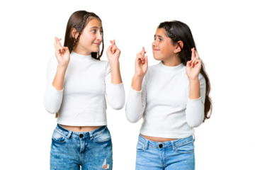 Friends girls holding gift and a birthday cake over isolated chroma key background with fingers crossing and wishing the best