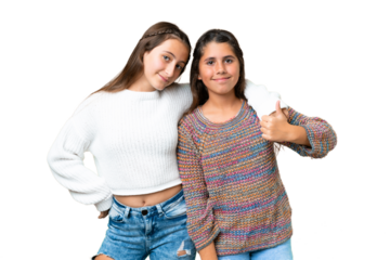 Friends girls over isolated chroma key background giving a thumbs up gesture
