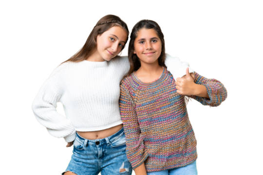 Friends girls over isolated chroma key background giving a thumbs up gesture