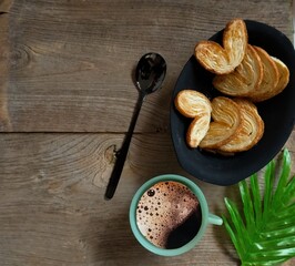 coffee and croissant with spoon on the table 