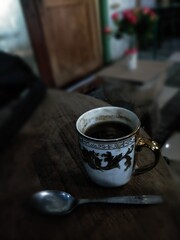 Cup of coffee and spoon on night view 