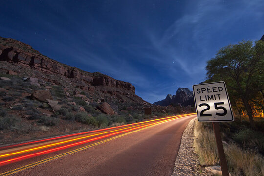 Light trails on road in desert at Zion National Park, Utah, USA