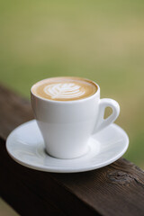 A cup of cappuccino on wooden table
