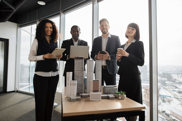 Team of diverse four multiethnic businesspeople having meeting in boardroom at office with...