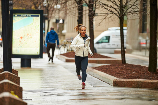 A female runner running through the city