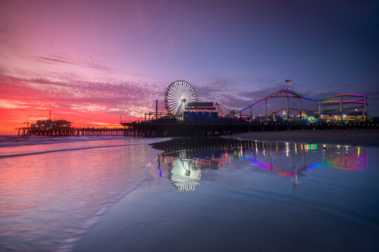Amusement park and Santa Monica Pier at sunset, Los Angeles, California, USA