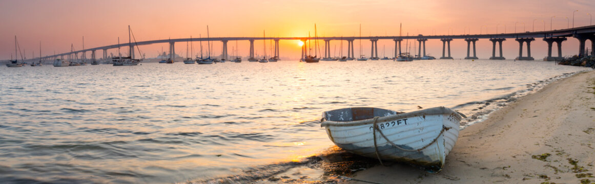 Rowboat on beach near Coronado Bridge, San Diego, California, USA