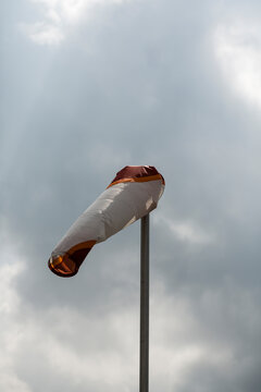 Windsock in front of dark clouds. Wasserkuppe, Rhoen Mountains, Germany