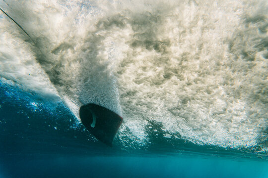 Underwater view of wave and surfer