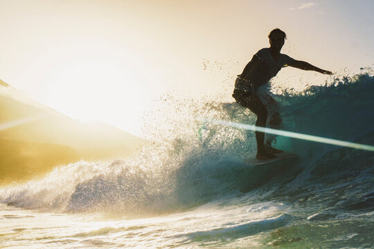 Young surfer having fun in afternoon surf session, Fuerteventura, Canary Islands, Spain