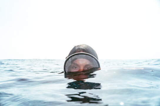 Close-up surface level of woman emerging from underwater, Tenerife, Canary Islands, Spain