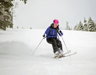 Female skier shredding bumps on slope