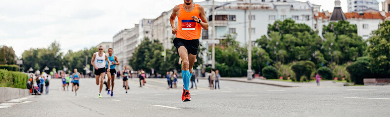 athlete runner leader to run marathon race ahead group of runners