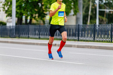 Fototapeta na wymiar man runner athlete in compression socks running city marathon race