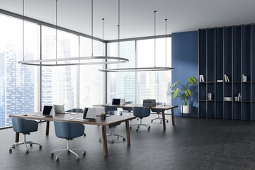 Office interior with computer and armchair, panoramic window on city view