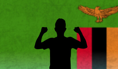 Young man in front of the Zambia flag, fists up of happy man, happiness or joy concept