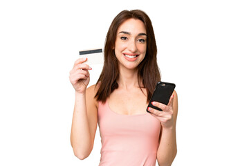 Young caucasian woman over isolated chroma key background buying with the mobile with a credit card