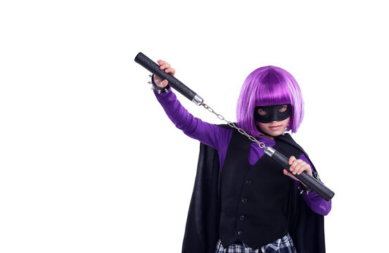 A little girl in a Halloween contest character dressed up in character with nunchucks for fighting. A kid girl with martial art karate weapons and a purple hair wig isolated on a png background.