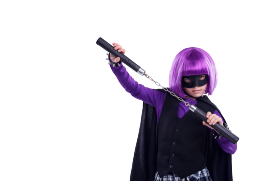 A little girl in a Halloween contest character dressed up in character with nunchucks for fighting. A kid girl with martial art karate weapons and a purple hair wig isolated on a png background.
