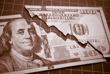 Tear off US dollar bill banknote as chart graph falling down. The Federal Reserve ( FED ) increase...