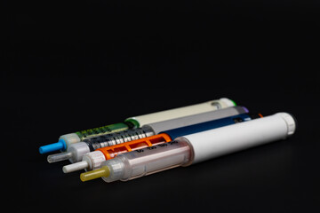 insulin syringe pen on black background 
