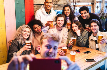 Happy friends taking a group selfie at pub