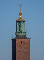 Tower with three golden crowns of the Town City Hall, a winter day in Stockholm