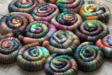 Closeup detail of handmade rolags of sheep wool and other fibres which were blended on a blending...