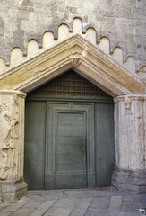 Fototapeta na wymiar One of the entrances of Como Cathedral in Como, Italy