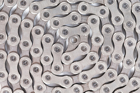 Extreme Closeup Image of New Clean Oiled Twisted Circled Bicycle Chain Isolated Over White Background.